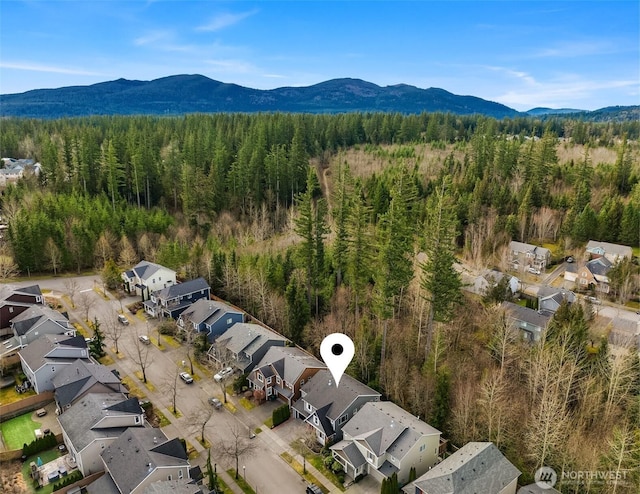 bird's eye view featuring a mountain view and a view of trees