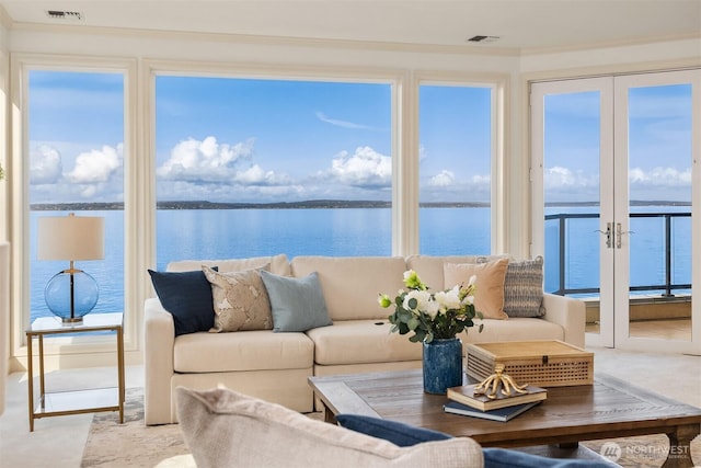 sunroom / solarium featuring a water view and visible vents