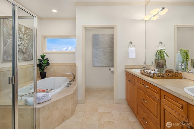 bathroom featuring a garden tub, a sink, double vanity, and crown molding
