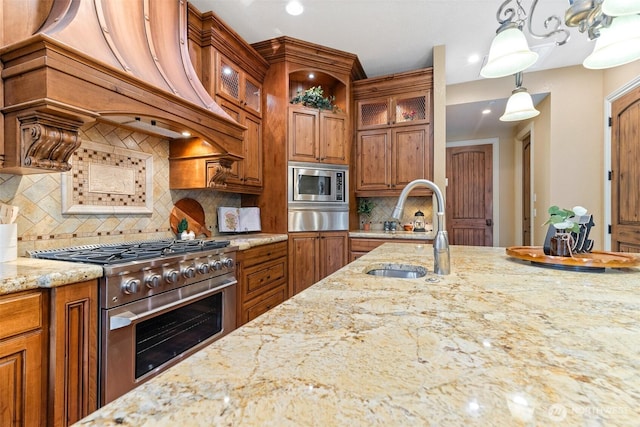 kitchen featuring brown cabinets, custom exhaust hood, stainless steel appliances, a sink, and a warming drawer