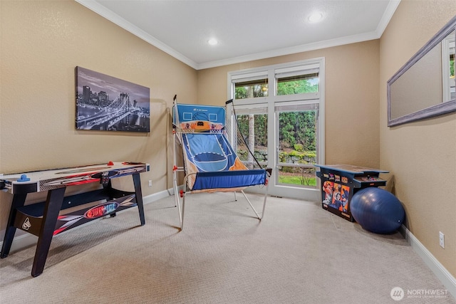 recreation room with carpet, baseboards, ornamental molding, and a wealth of natural light