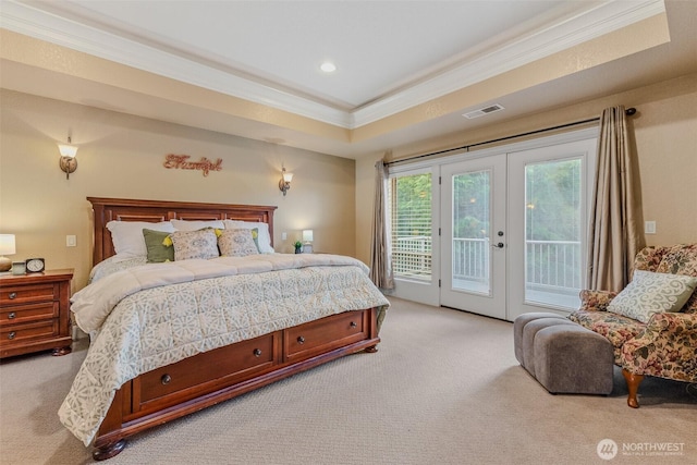 bedroom with visible vents, ornamental molding, access to outside, a tray ceiling, and french doors