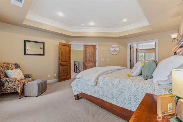 bedroom featuring ornamental molding, a raised ceiling, light colored carpet, and visible vents