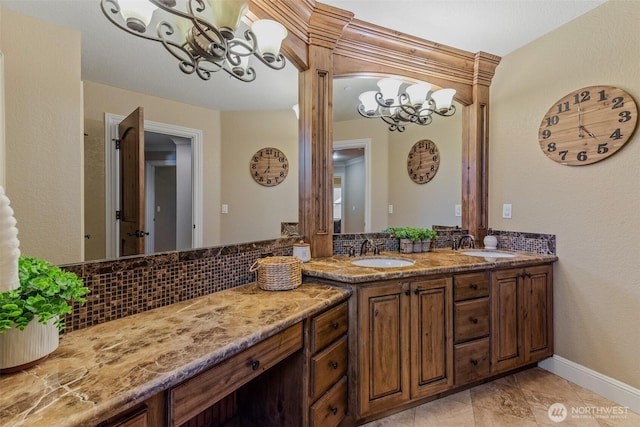 full bath featuring a notable chandelier, a sink, decorative backsplash, and double vanity