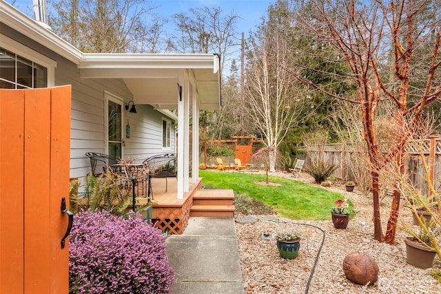 view of yard with a deck and fence