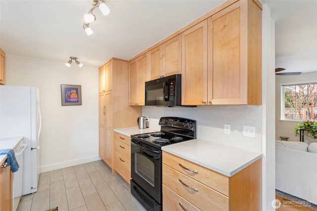 kitchen featuring baseboards, black appliances, light brown cabinetry, and light countertops