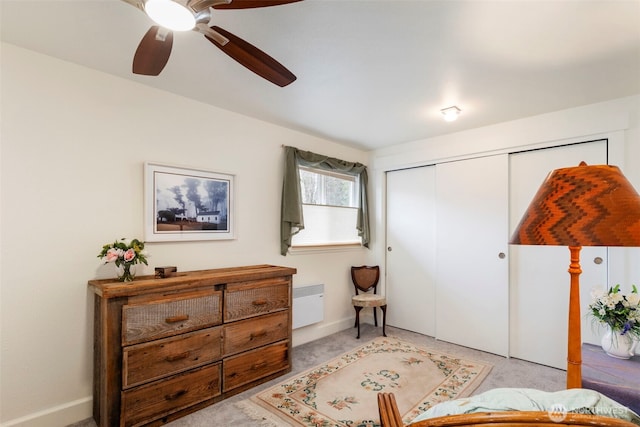 bedroom with a closet, baseboards, and ceiling fan