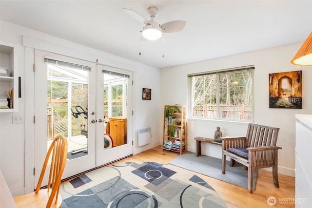 doorway with light wood-style floors, baseboards, french doors, and ceiling fan