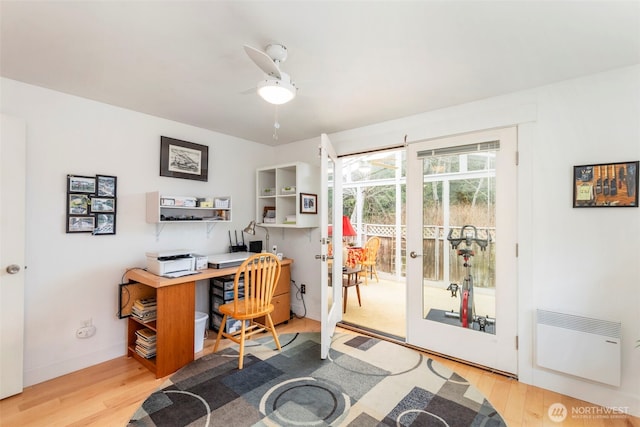 office space featuring french doors, baseboards, wood finished floors, and a ceiling fan