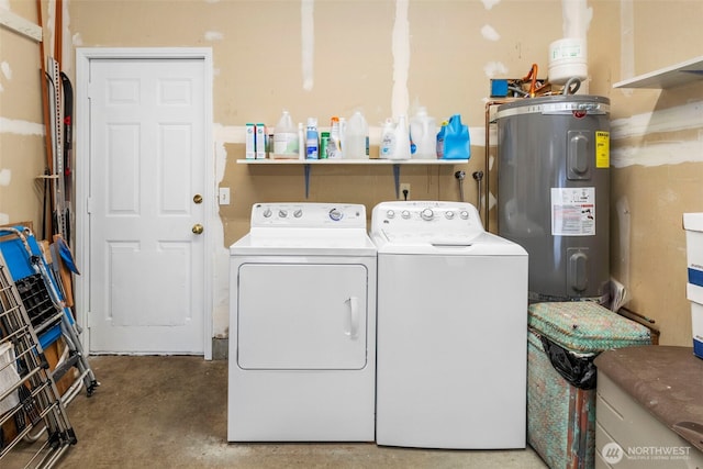 clothes washing area with laundry area, water heater, and washer and clothes dryer