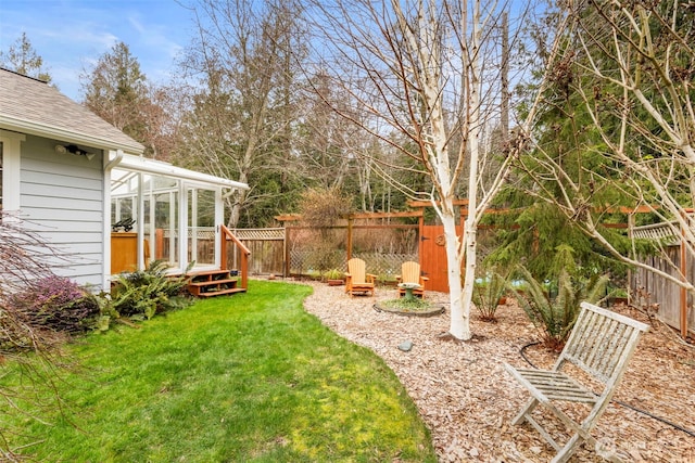 view of yard with a sunroom and fence