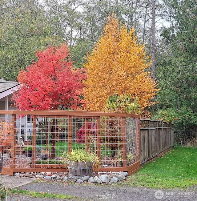 view of gate with a garden and fence