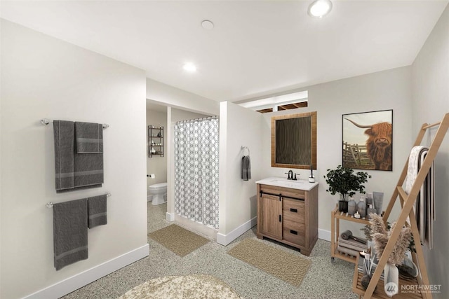 bathroom featuring recessed lighting, baseboards, vanity, and toilet