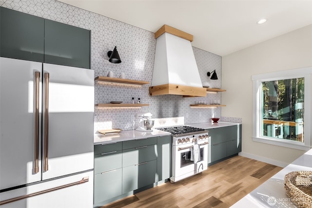 kitchen with premium appliances, backsplash, custom exhaust hood, and open shelves