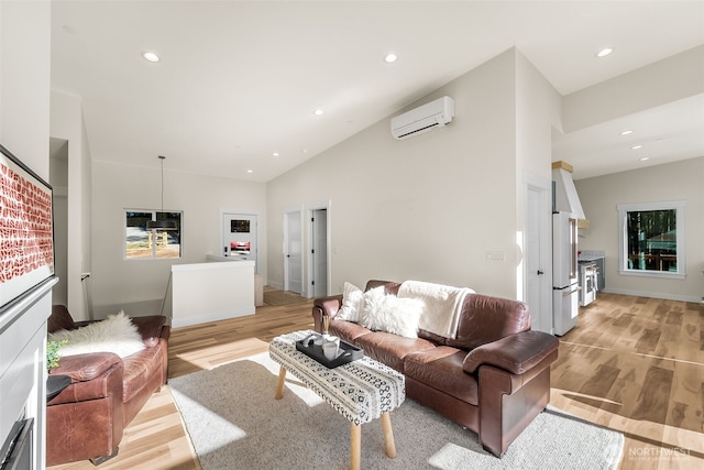 living room featuring light wood-type flooring, recessed lighting, high vaulted ceiling, and a wall mounted AC