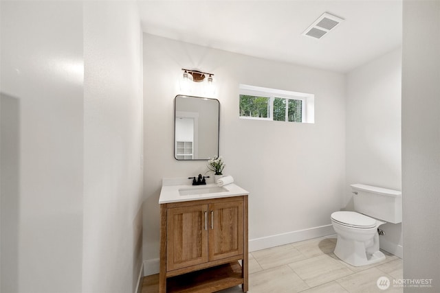 bathroom with toilet, baseboards, visible vents, and vanity