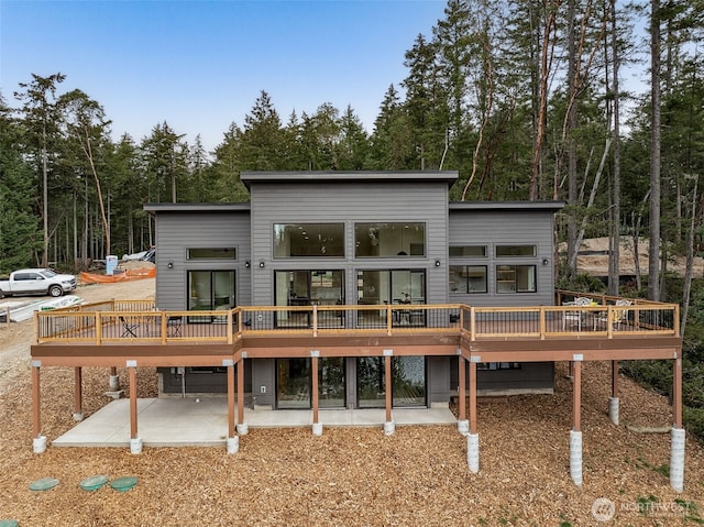 rear view of house featuring a deck and a patio