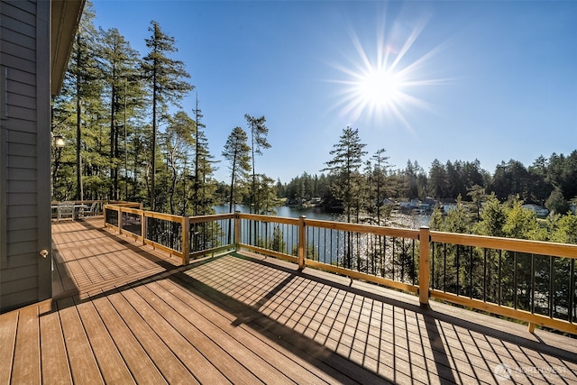 wooden terrace featuring a water view