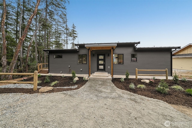 contemporary home featuring fence