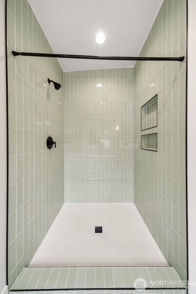 full bath featuring a tile shower