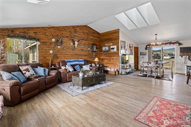 10893 Brick Mill Rd, Ellensburg, WA 98926 - living area with plenty of natural light, wooden walls, a notable chandelier, and a skylight