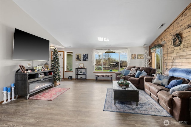 10893 Brick Mill Rd, Ellensburg, WA 98926 - living room featuring wood finished floors, visible vents, baseboards, and lofted ceiling