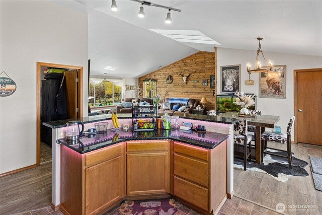 10893 Brick Mill Rd, Ellensburg, WA 98926 - kitchen featuring a center island, open floor plan, a chandelier, wooden walls, and lofted ceiling