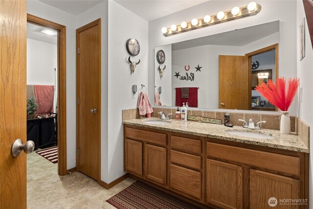 10893 Brick Mill Rd, Ellensburg, WA 98926 - full bathroom with a sink, baseboards, and double vanity