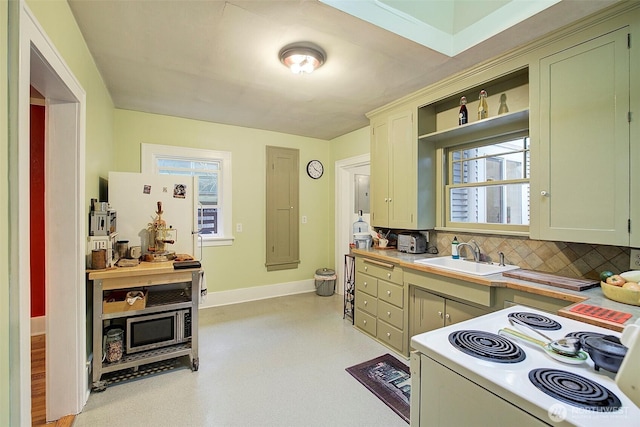 kitchen featuring a sink, backsplash, white electric stove, baseboards, and light floors