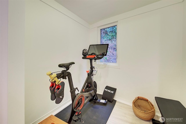 workout room featuring wood finished floors and baseboards