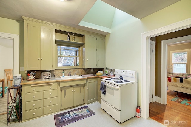 kitchen featuring white range with electric cooktop, tasteful backsplash, a wealth of natural light, and a sink