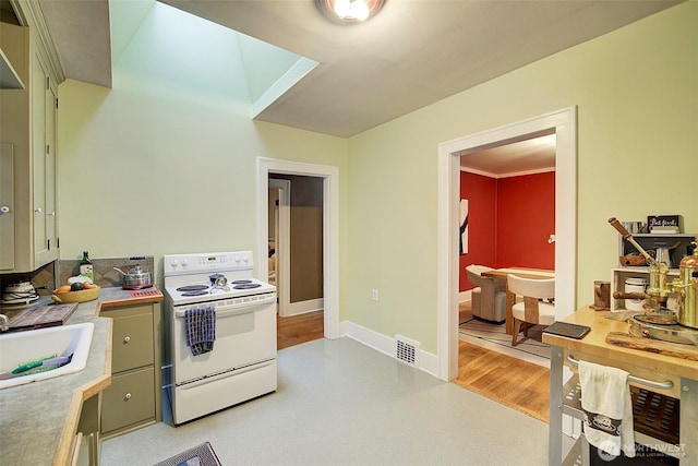 kitchen featuring visible vents, baseboards, light countertops, white electric range, and a sink