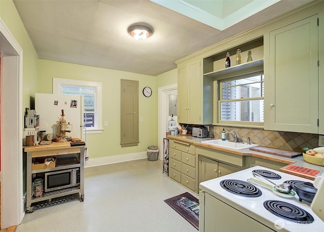 kitchen with decorative backsplash, electric range, a sink, baseboards, and light countertops