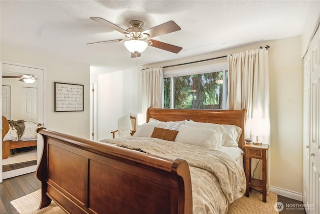 bedroom featuring wood finished floors, a ceiling fan, and baseboards