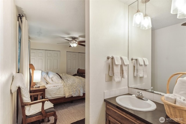 ensuite bathroom featuring a ceiling fan, vanity, and ensuite bathroom