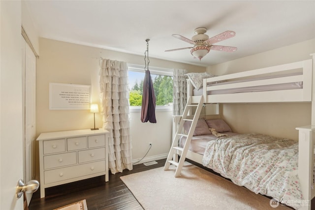 bedroom featuring a ceiling fan, baseboards, and dark wood-style flooring