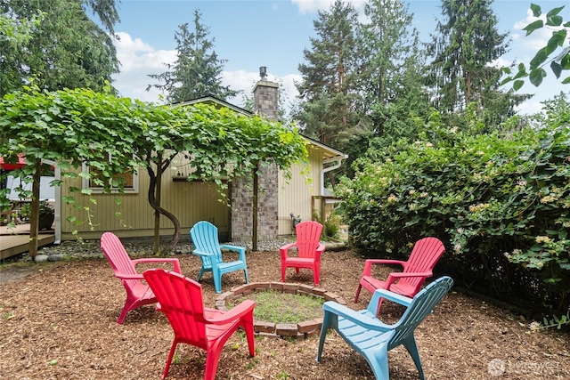 view of yard with a fire pit and a wooden deck