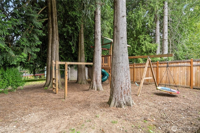 view of jungle gym with a trampoline and fence