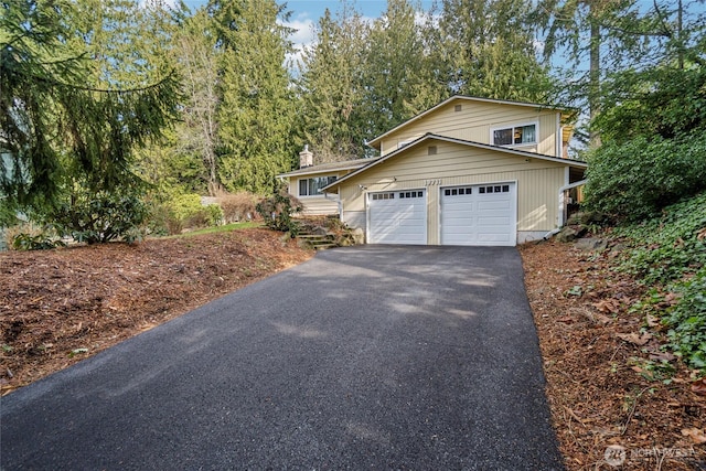 view of front of home featuring a garage and aphalt driveway