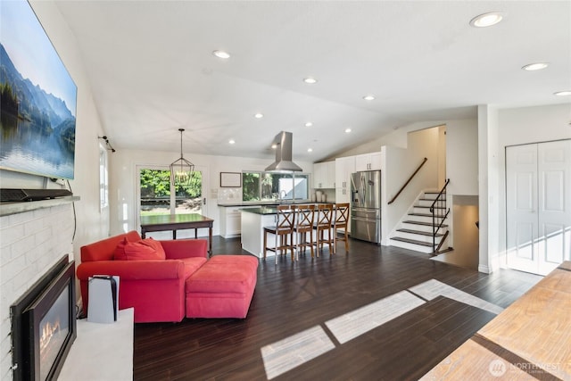 19711 34th Dr SE, Bothell, WA 98012 - living room with a glass covered fireplace, dark wood-style flooring, vaulted ceiling, stairway, and recessed lighting