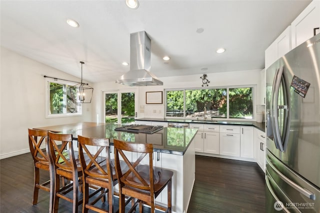 19711 34th Dr SE, Bothell, WA 98012 - kitchen featuring appliances with stainless steel finishes, island exhaust hood, a sink, dark countertops, and plenty of natural light