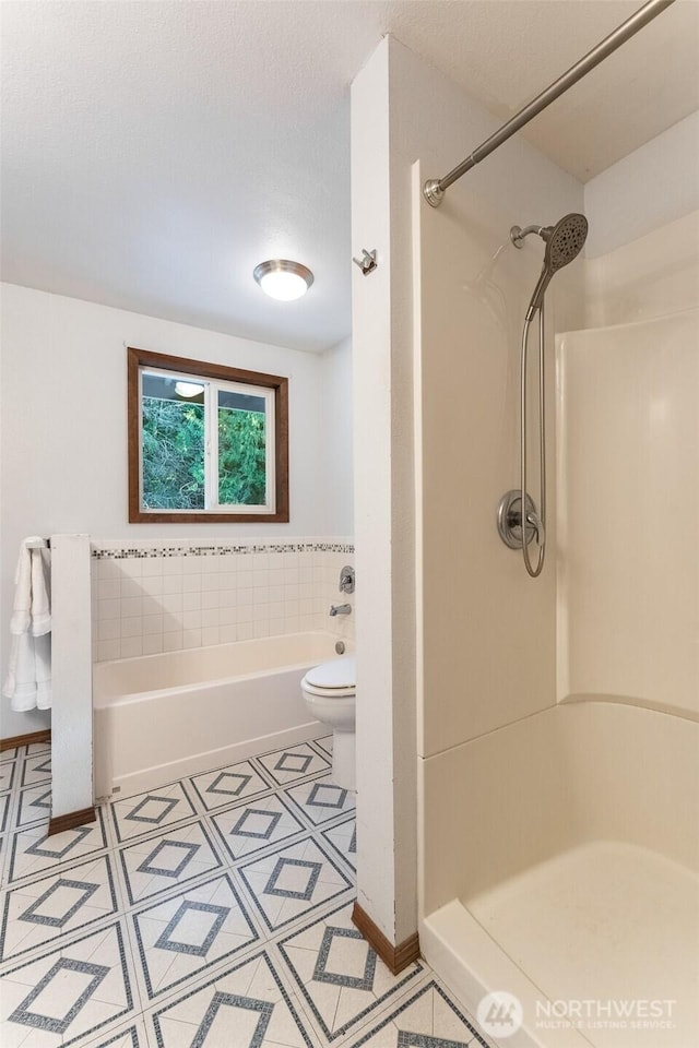 full bath featuring toilet, a stall shower, a washtub, and a textured ceiling