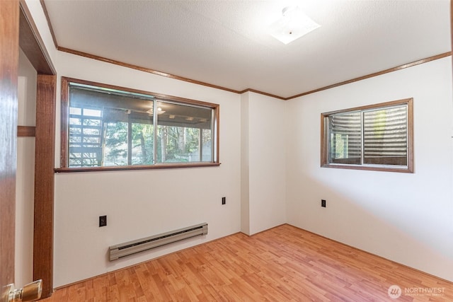 empty room featuring a baseboard radiator, a textured ceiling, light wood-style flooring, and crown molding