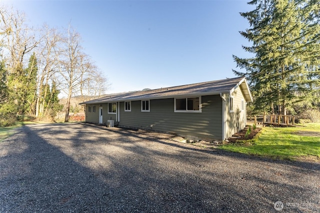 exterior space with cooling unit and gravel driveway