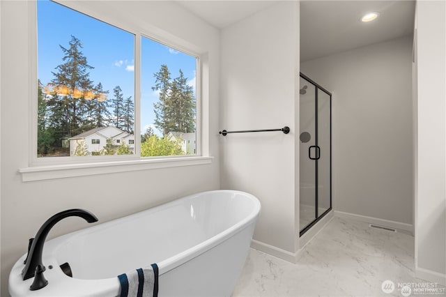 bathroom featuring baseboards, marble finish floor, a freestanding tub, a shower stall, and recessed lighting