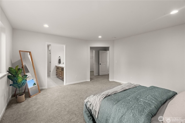 bedroom featuring recessed lighting, light carpet, ensuite bath, and baseboards