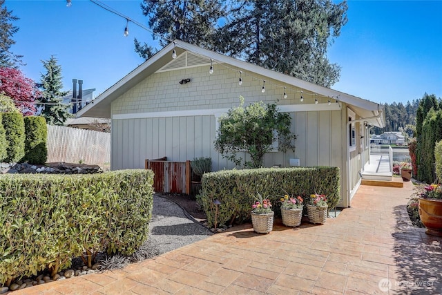 exterior space with board and batten siding and fence