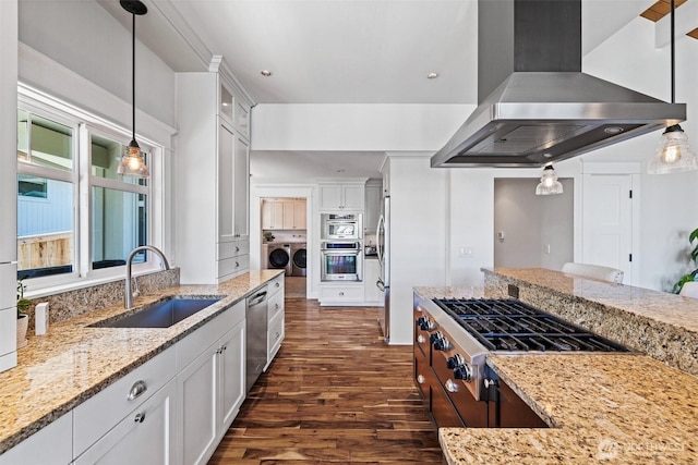 kitchen featuring stainless steel appliances, white cabinetry, a sink, island range hood, and separate washer and dryer