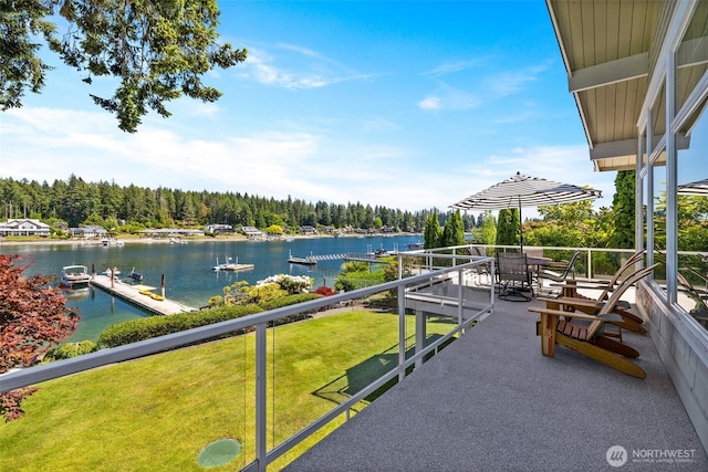 exterior space with a water view and a wooded view