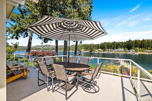 view of patio / terrace with a water view and a balcony